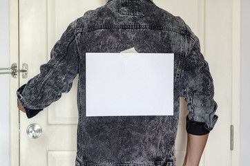 A blank  white note on sticky tape of the man back side with empty space for text. April fools day...