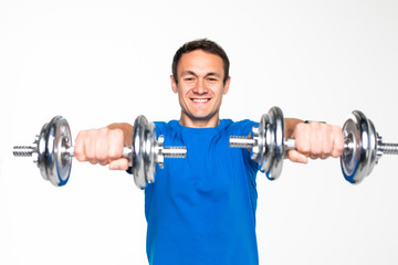 Handsome young man exercising with dumbbells on white background