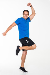 Happy young man jumping isolated on a white background