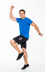 Happy young man jumping isolated on a white background