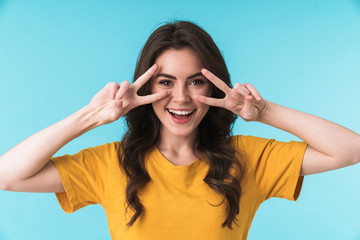 agCheery young pretty woman showing peace gesture.