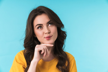 Dreaming pleased young pretty woman posing isolated