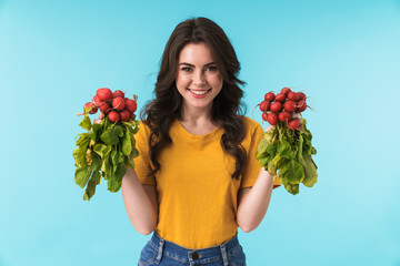 Cheerful young girl holding radish.