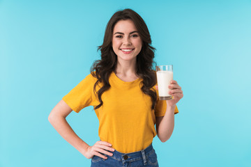 Positive optimistic young beautiful woman holding milk.