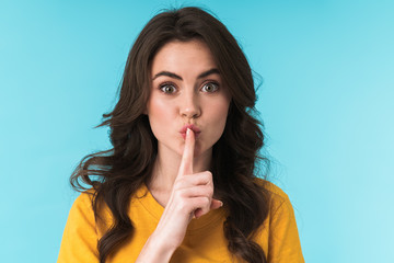 Naklejka premium Woman posing isolated showing silence gesture.