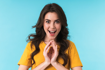 Cunning woman posing isolated over blue wall background.