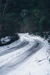 Obraz premium Scenic curvy winter road in the forest
