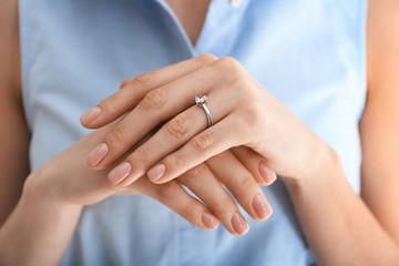 Young woman wearing beautiful engagement ring, closeup