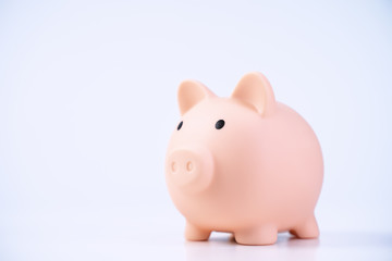 Financial concpet - Piggy bank, beautiful red white wooden house model on white background, saving money to buy insurance, close up, copy space.