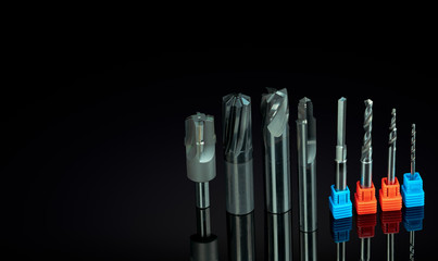 Special tools isolated on black background. Made to order special tools. Coated step drill and reamer detail. HSS cemented carbide. Carbide cutting tool for industrial applications. Engineering tools.