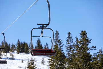 Empty chairlift at mountain ski resort. Winter vacation