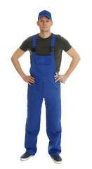 Fototapeta premium Full length portrait of professional auto mechanic with wrenches on white background