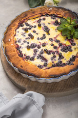 clafoutis - traditional french berries pie, dessert on rustic wooden table.
