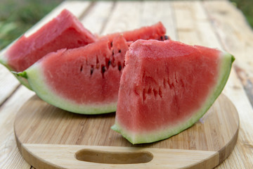 Fresh ripe sliced watermelon on wooden rustic background