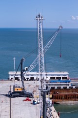2 units of Harbor Mobile Crane (HMC) are being loaded onto barges