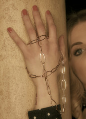 Girl in a white dress with a silver chain around her neck The bride fixes a decoration of a jewel on the neck Stylish fashionable diamond suspension girl's neck pendant pendant for women's neck