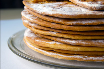 Round baked cake layers stacked on a plate.