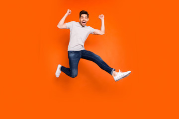 Full length photo of attractive crazy guy jump high supporting favorite football team match game...