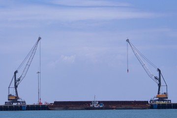 Fototapeta premium 2 units of Harbor Mobile Crane (HMC) are being loaded onto barges