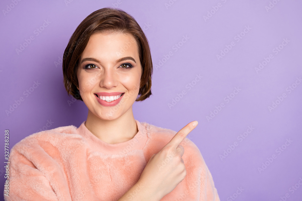 Wall mural Close up photo of charming girl promoter point index finger copy space demonstrate promo option advertising way wear casual style soft clothing isolated over violet color background