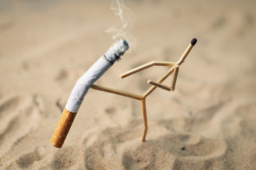 Fototapeta stop smoking; anthropomorphic match kicking cigarette obraz