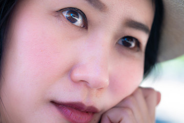 Close up Asian woman sees her eyes looking wide