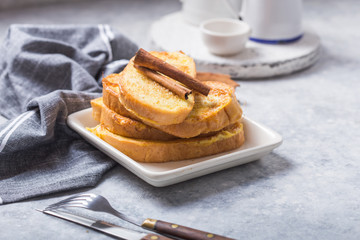 Traditional homemade Spanish torrijas on wooden background. Easter dessert.