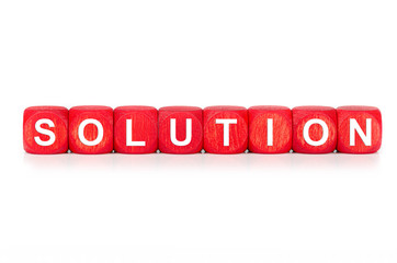 term SOLUTION - built from red wooden cubes on white background, isolated
