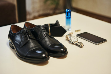 different accessories of a businessman for creating a style of a people lie on a wooden background