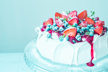 Obraz na płótnie Canvas Dessert - Pavlova meringue cake with fruits on pastel blue