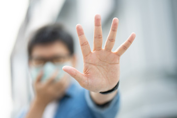 HandsomeMan wearing face mask protect filter against air pollution (PM2.5) or wear N95 mask. protect pollution, anti smog and Covid 19 viruses, Air pollution caused health problem. Global warming.