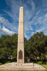 A granite civil war memorial under blue skies in park
