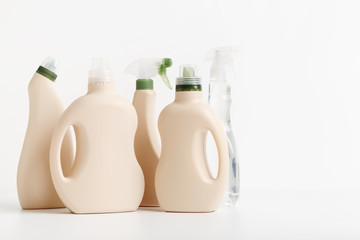 Detergent bottles and chemical cleaning supplies on white