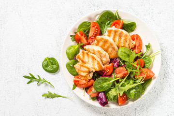 Salad with Grilled chicken, green leaves and vegetables.