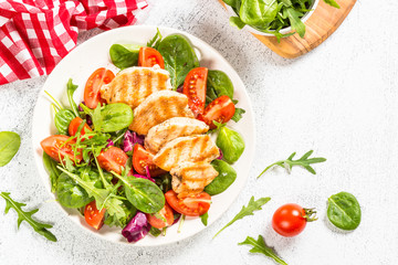 Salad with Grilled chicken, green leaves and vegetables.