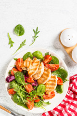Salad with Grilled chicken, green leaves and vegetables.