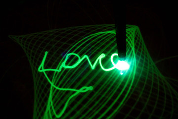 A grid of neon light. Drawing with light. The word Love is written on a light-sensitive surface.