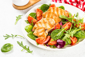 Salad with Grilled chicken, green leaves and vegetables.
