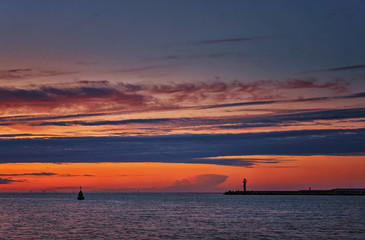 Colorful night scene on the Baltic Sea with lighthouse in Swinemünde. Swinoujscie, Poland
