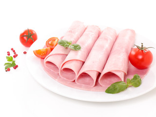 ham rolled up with basil and tomato on white background