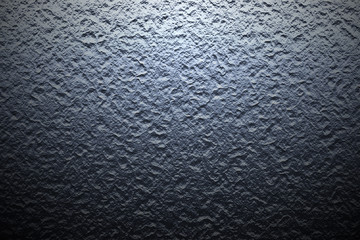 dark rock wall with light and shadow.