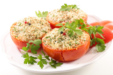 baked tomato with crumbs on wood background