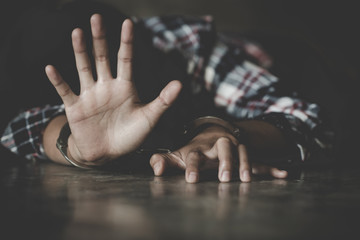 woman hands in handcuffs, human trafficking Concept, stop violence against women and human trafficking,  international women's day.