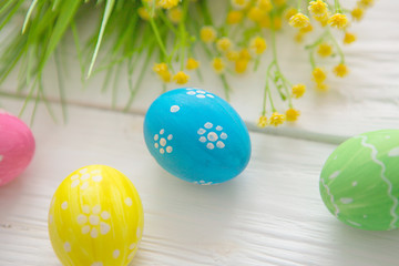 Easter eggs on a white wooden surface