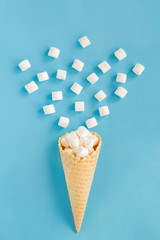 Waffle cone with marshmallow on a blue background