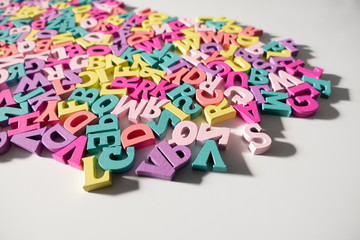 Plenty of colorful wooden letters on a White background