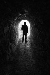 Silhouette of a man in a tunnel in black and white 