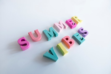 Obraz premium Summer word made of colorful wooden Letters isolated on a White Background