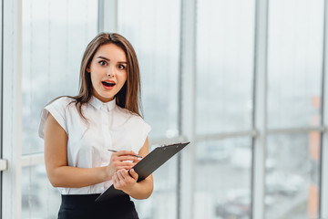 Researcher in formal business attire writes information on clipboard, isolated on white.