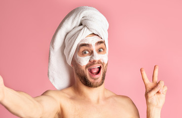 Man with mask on his face shows peace sign
